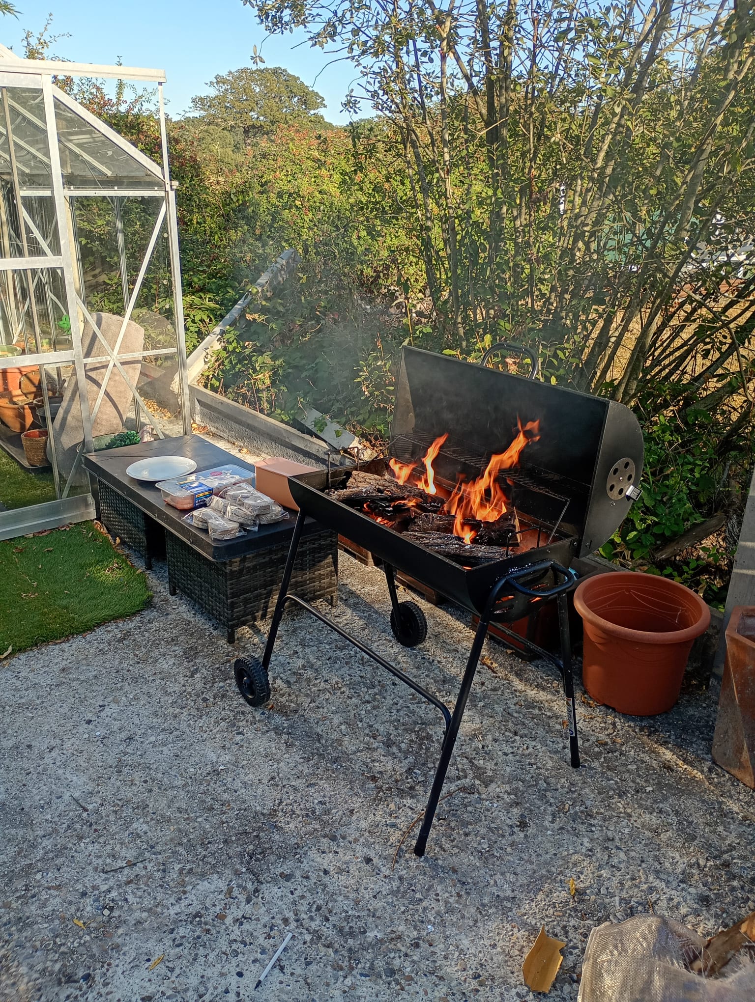 Firewood burning in an outdoor BBQ grill